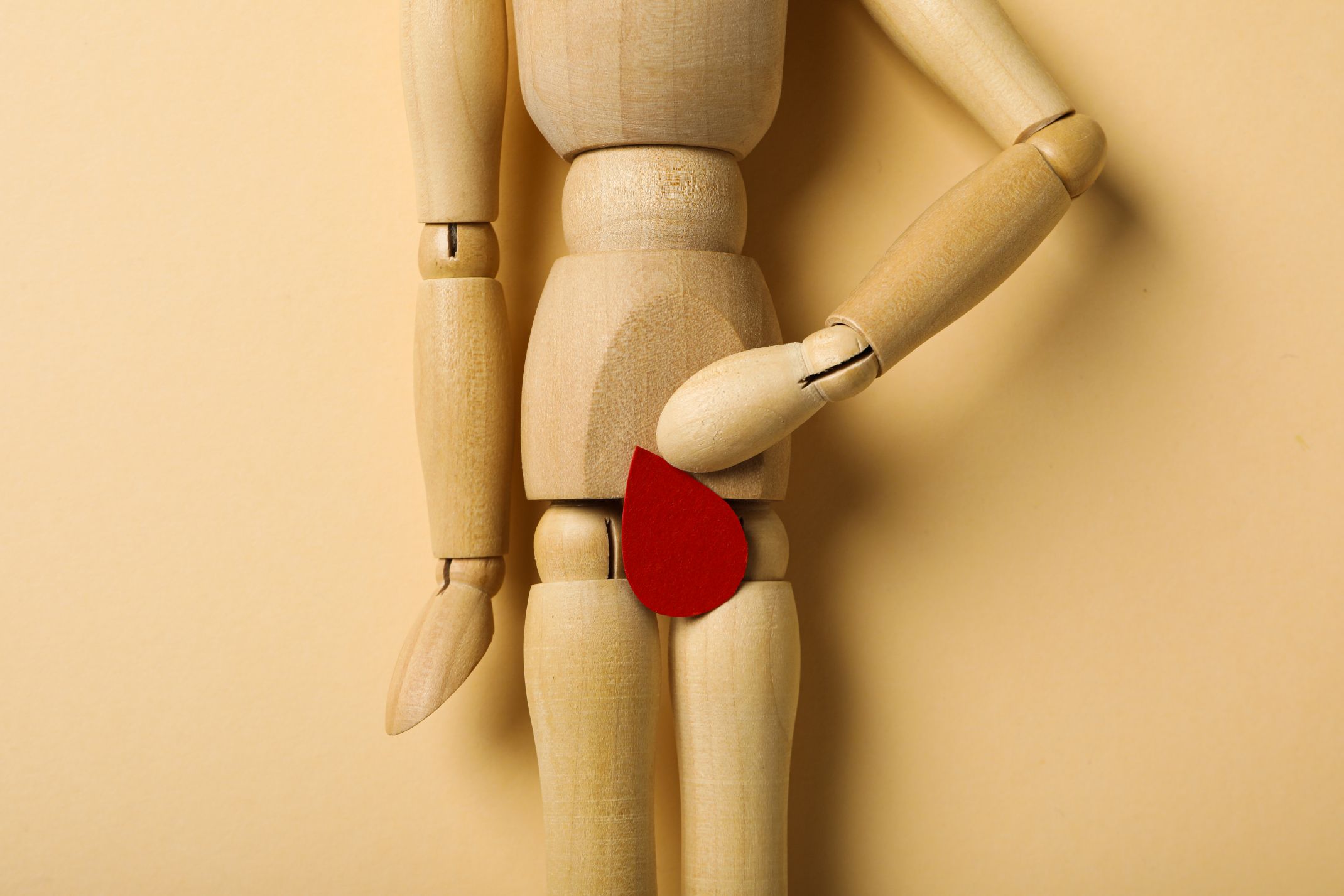 menstrual cycle concept wooden figurine of a man