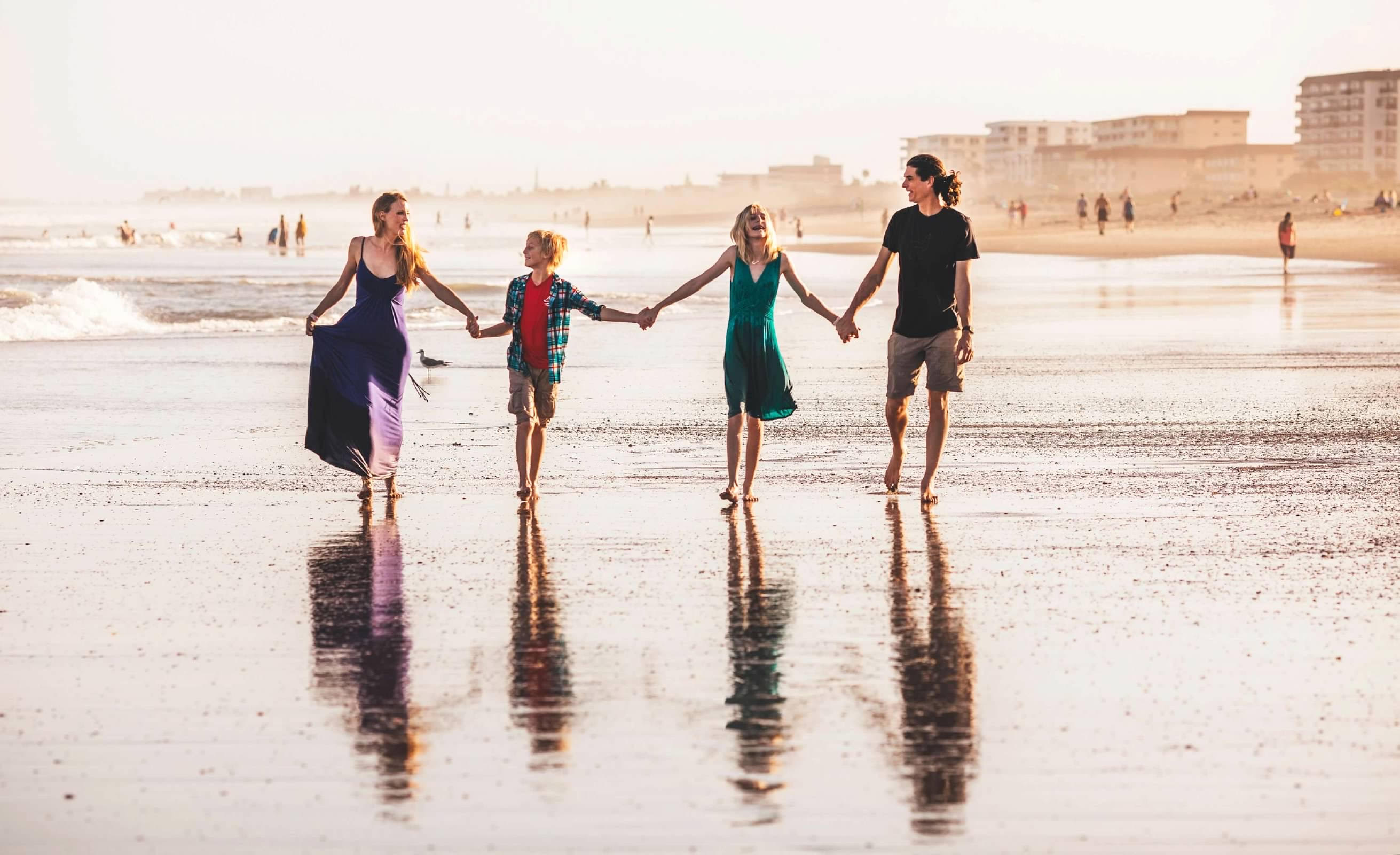 Dr. Loftis and their family walking on the beach
