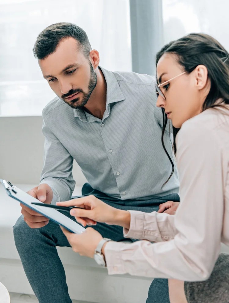 A physician explaining a form to a patient