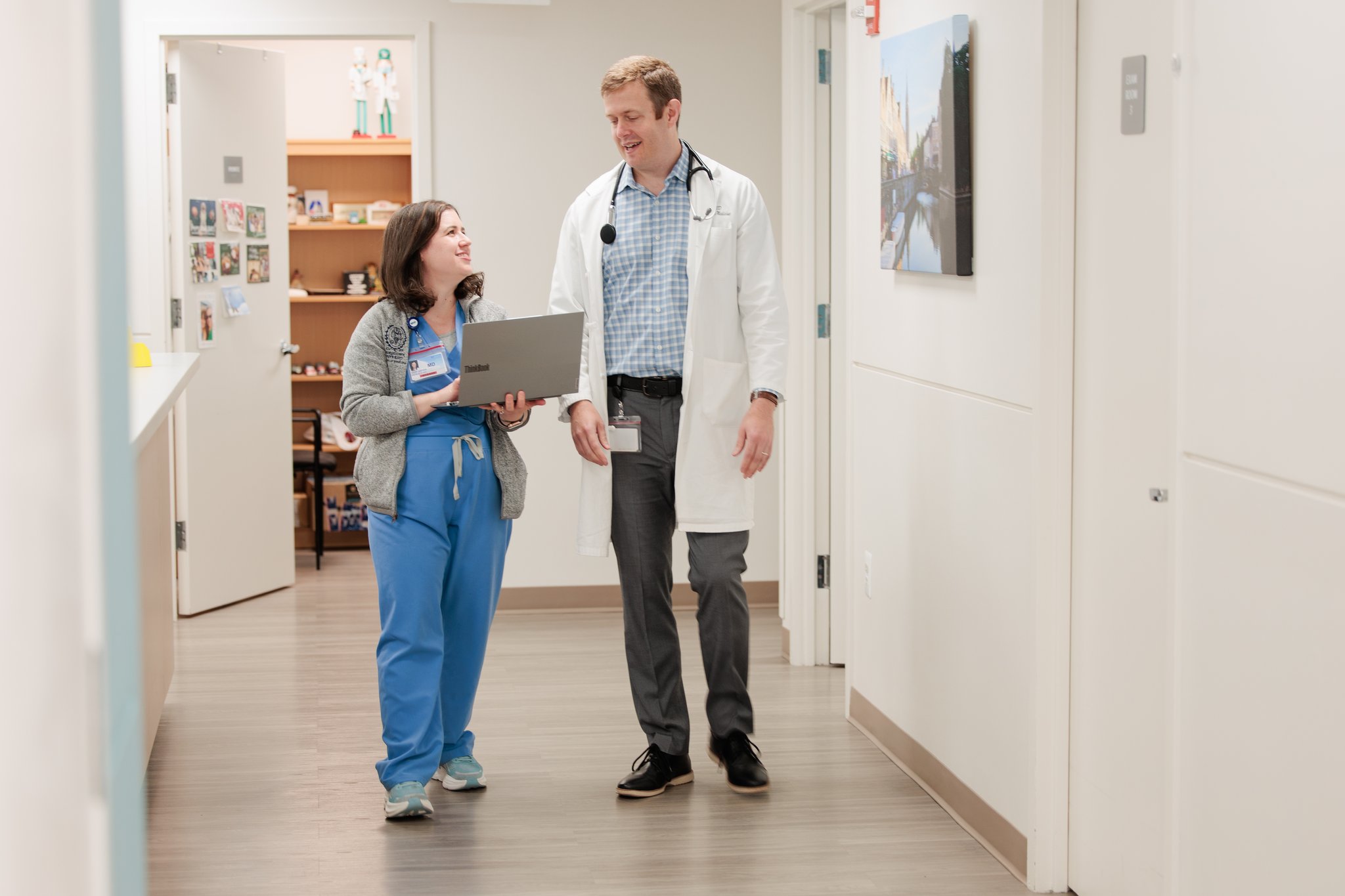 A physician and nurse in a discussion while walking