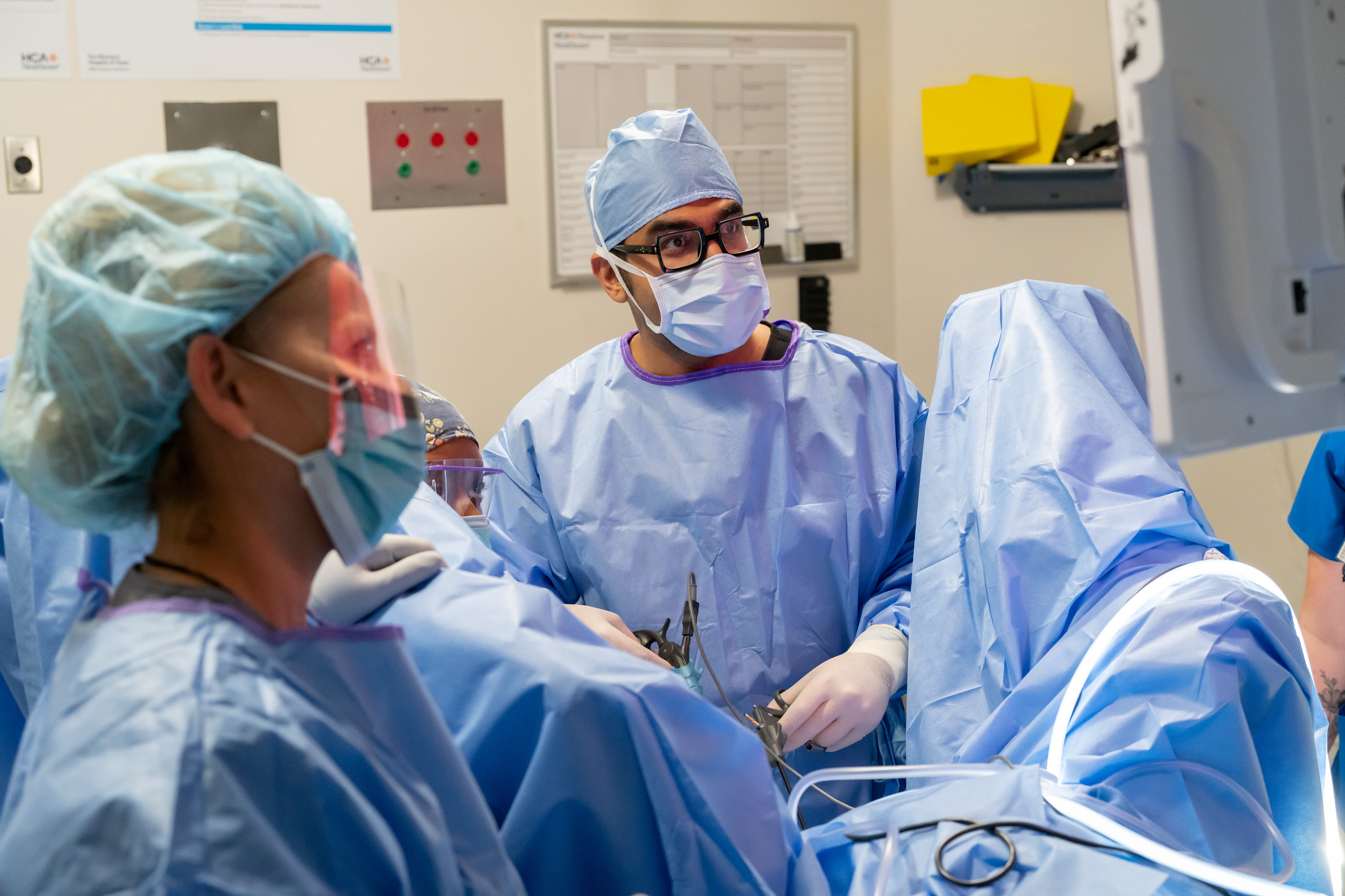 A physician and medical staff working together during a surgery