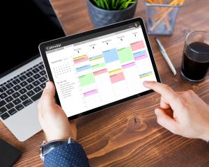 A patient looking at a tablet with their schedule