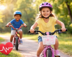 Two children riding bikes outdoors to promote children’s heart health and active lifestyles