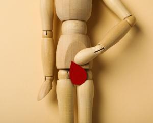 menstrual cycle concept wooden figurine of a man