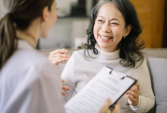 A doctor filling out paperwork with a patient