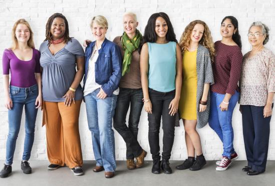 A group of women standing next to eachother