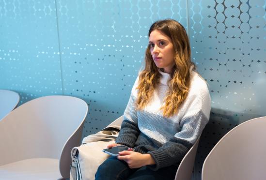 A woman sitting in the waiting room