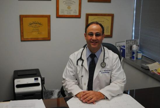 Robert A. Nussbaum sitting at his desk