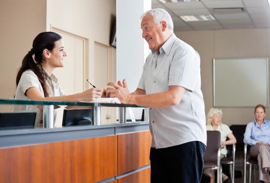 A patient checking in at the front desk