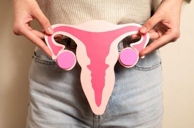 kbmd_front-view-woman-holding-reproductive-system