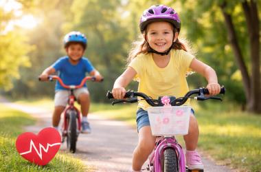 Two children riding bikes outdoors to promote children’s heart health and active lifestyles