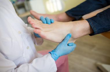 A physician examining a patients foot