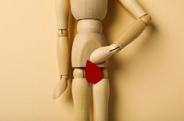 menstrual cycle concept wooden figurine of a man