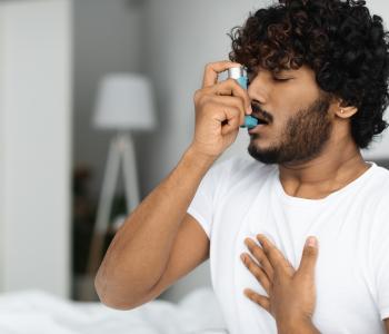 A man using an inhaler 