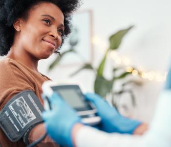 A physician taking a patient's blood pressure