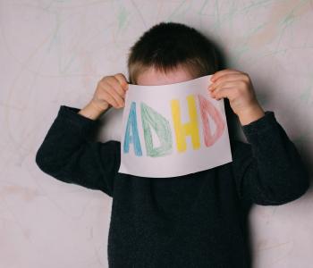 A child holding an ADHD sign