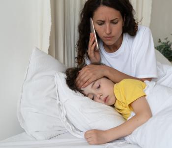 A mother on the phone for her sick child