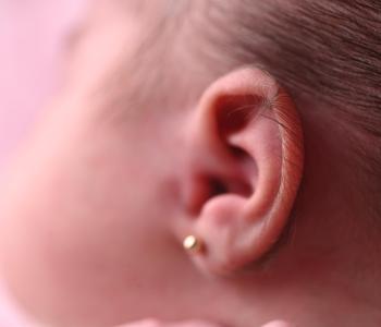 A small child with an ear piercing