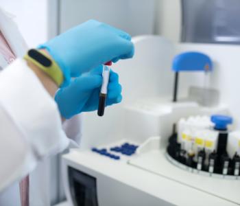 Doctor in a white robe getting the test tubes ready for analysis