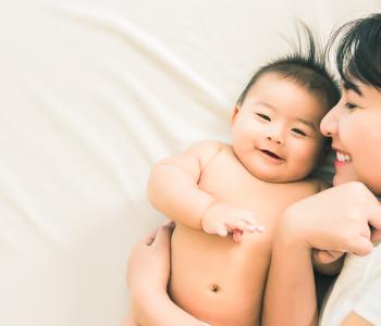 A mother and child laying in bed