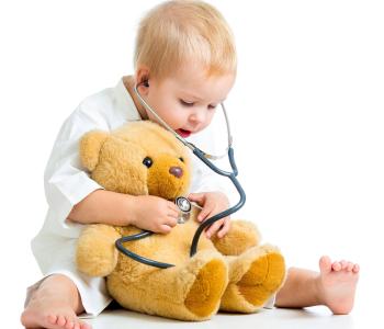 A child using a stethoscope on a teddy bear
