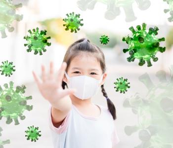 A child with her arms outstretched to keep germs away