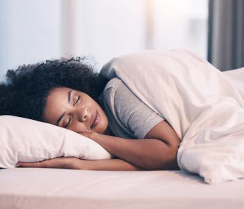 A woman sleeping in her bed