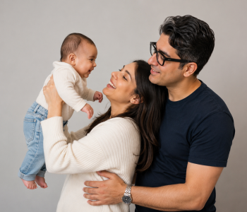 A mother and father holding their baby